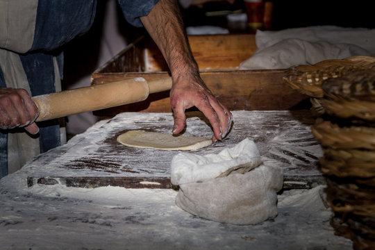 Man rolls the dough in Nazareth Village