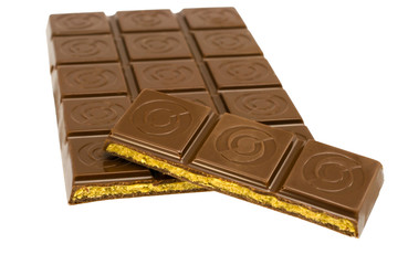 a broken tile with caramel filling of chocolate isolated on whit