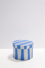 Blue striped pattern round box on white desk