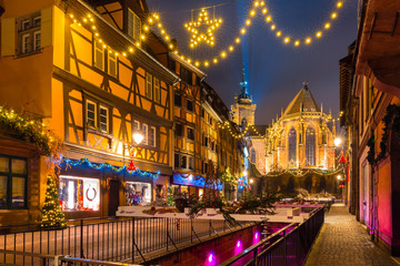 Saint Martin Church in old town of Colmar, decorated and illuminated at christmas time, Alsace, France - obrazy, fototapety, plakaty