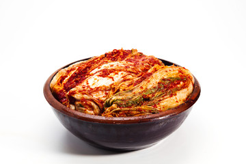 Kimchi on a crock head on white background