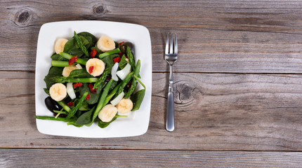 Overhead view of a nutritional fresh salad on rustic table