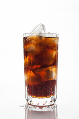 Cola with ice in a glass on white background