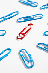 Color paper clips on white background 