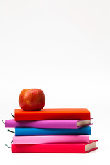 Colorful stack books with a fresh apple isolated 