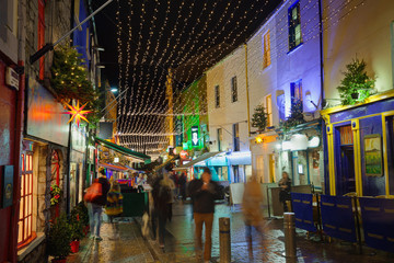 Fototapeta premium Street decorated with Christmas lights at night