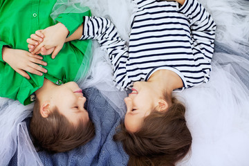 Young children lying in bed concept of love and Valentine's Day.