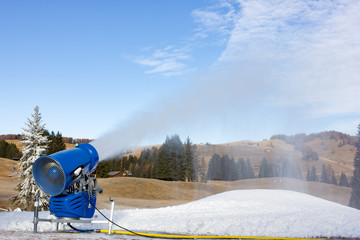 Cannon fires snow on the ski slopes