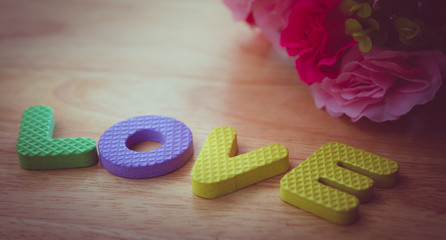 LOVE word made from foam alphabets place on wooden table- pink c