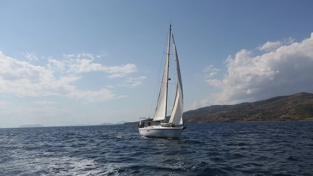 Sailing ship luxury yacht boat with white sails in the Sea.