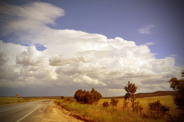 Obraz premium Beautiful cloudscape and storm over road through countryside, New South Wales, Australia. Retro toned image.