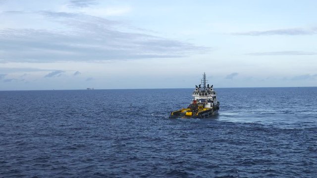 Offshore supply vessel standby at long distance from the rig and wait to discharge cargo to an oil rig
