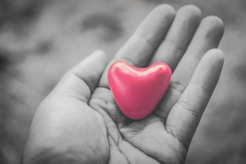 hand holding a red heart, valentine's day love, vintage tone 