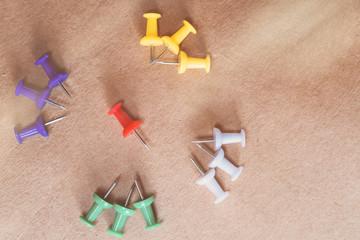 thumbtacks pinned arrange to symbolize on wooden table to be different or leadership or bravery with copy space, vintage tone

