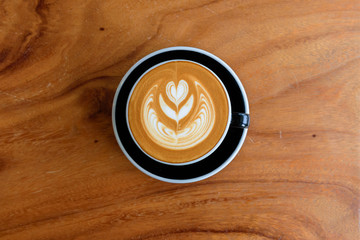 Latte Art, coffee on wood texture backgroud