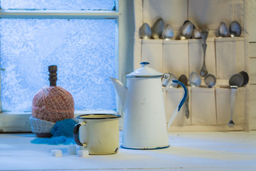 Hot coffee pot and cup with spoons in winter