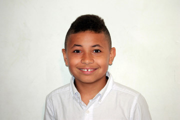 Young Biracial Boy Smiling on White Background