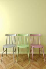 Three simple chair in empty room.