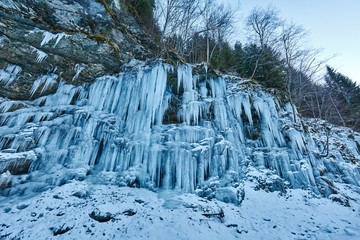 Fototapeta na wymiar Frozen waterfall in the mountains