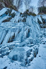 Fototapeta na wymiar Frozen waterfall in the mountains