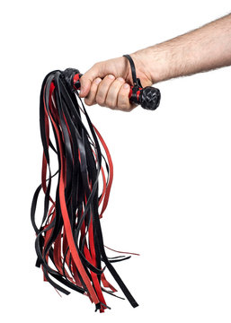 Hand grasps the whip (floger). Isolated on white