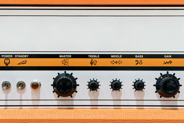 Orange sound control panel with signs, switches, regulators and copyspace