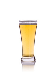 Beer in clear grass. Studio shot isolated on white