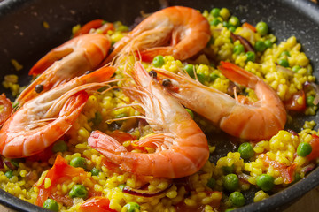 Spanish paella with seafood in a frying pan. Delicious lunch on 