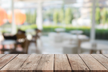 Wood table top and blurred restaurant exterior background - can used for display or montage your products.