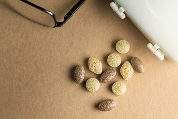 Closse up of herb Medicine with slice of drug box and glass on brown paper board