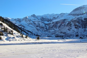 High plain and mountains in winter, at the head of the Gastein valley, Austria, Europe. In the region Nassfeld, Sportgastein, 1500 m above sea level.