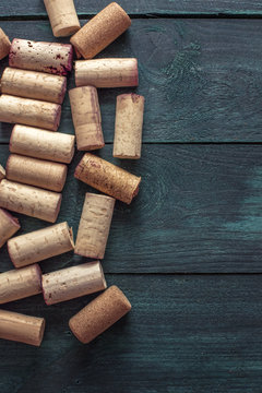 Wine corks on dark wooden texture with copyspace