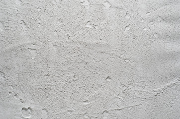 Grey concrete wall or floor. Cement background with visible texture. Natural bubble pattern backdrop. Closeup macro photograph. Top view