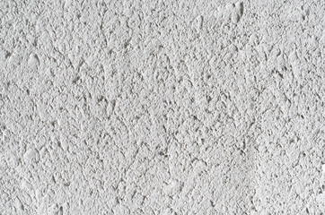 Grey concrete wall or floor. Cement background with visible texture. Natural bubble pattern backdrop. Closeup macro photograph. Top view