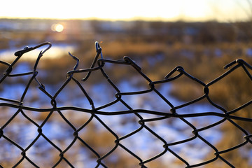 wire mesh fence in sunset background