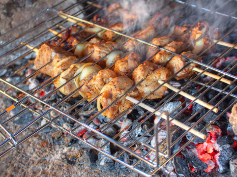 Shashlyk - traditional Russian barbeque  grilling outdoors on a gas barbecue grill.