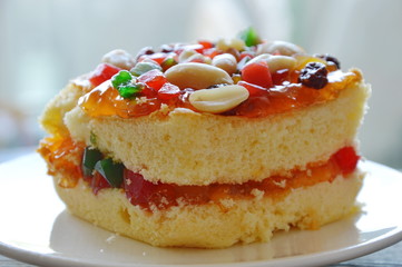orange butter cake topping peanut and dried fruit salad on dish