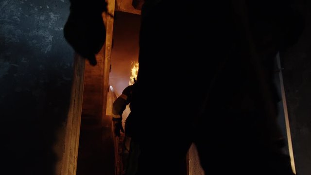 Fully Equipped Firefighters Enter Open Doors and Running Up Burning Stairs.  Shot on RED EPIC (uhd).