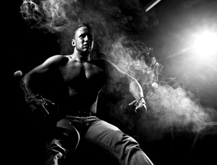 Fototapeta na wymiar muscular man and abstract smoke