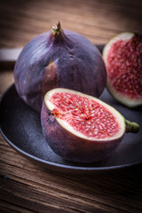 Sliced figs on a wooden table. Top view.