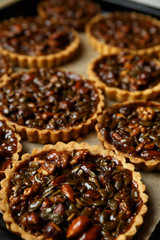 Not baked delicious cakes with nuts on pan.