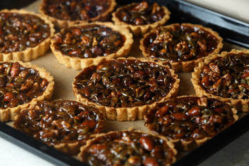 Not baked delicious cakes with nuts on pan.