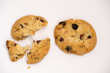 Two cookies with raisins broken into pieces.