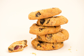 Fototapeta na wymiar Cookies with raisins folded pile on a white background