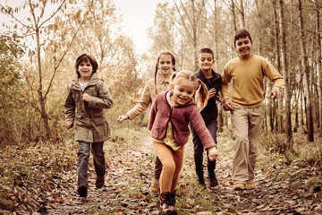 Children running together in a park.