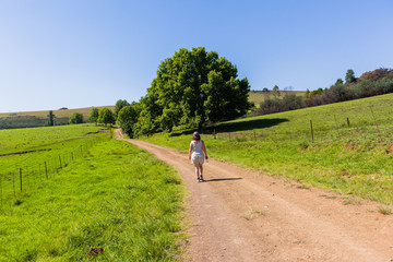 Obraz premium Woman Walking Farmlands
