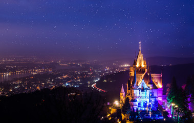 Beautiful illuminated castle at the river rhine at night. - obrazy, fototapety, plakaty