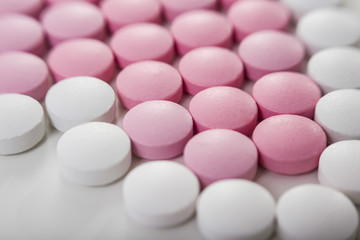 Fototapeta na wymiar Close up of white and pink pills