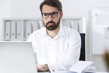 Fototapeta premium Bearded businessman making business plan