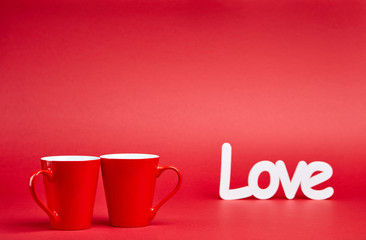 Red background with two cups and white love sign 